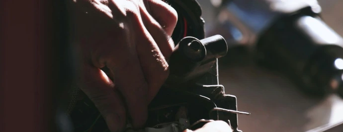 close up of hands repairing a firearm